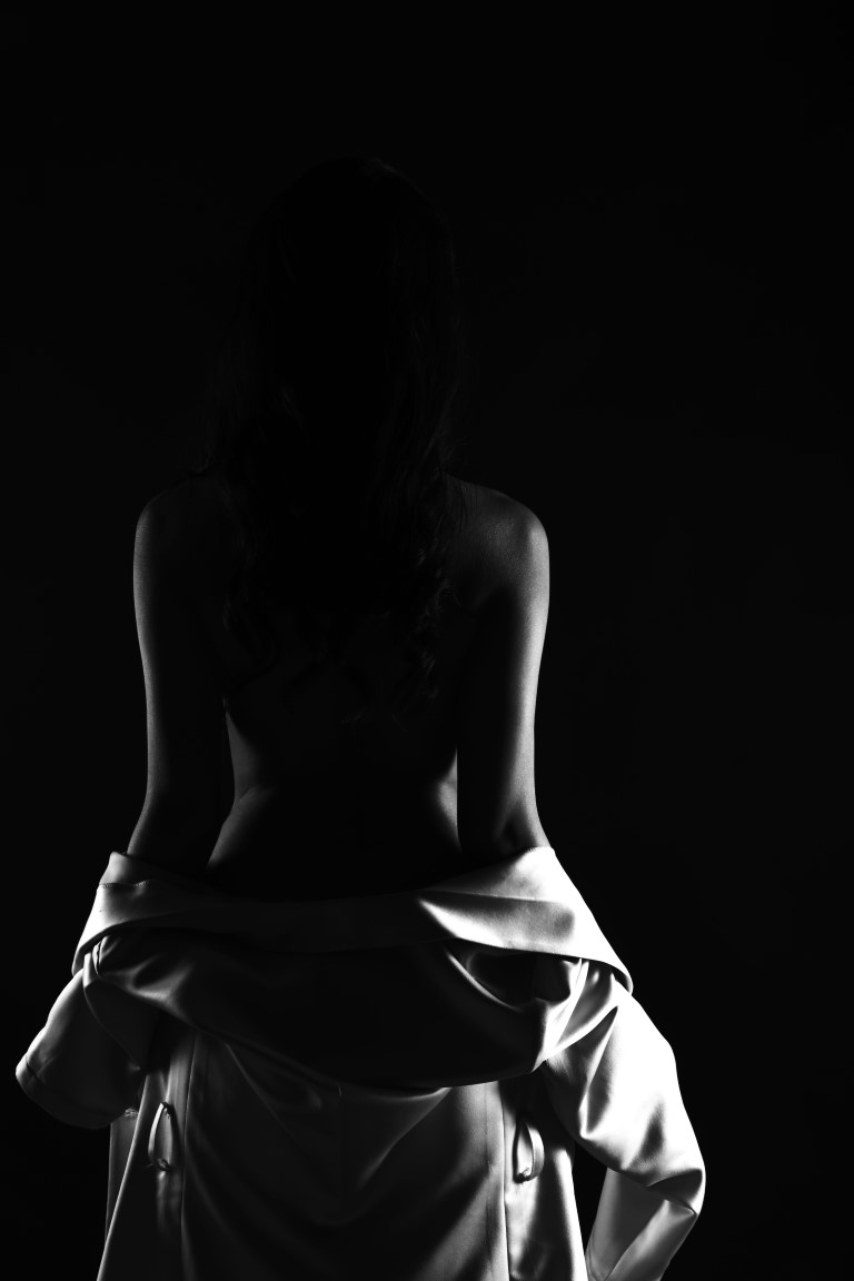 Body of Woman with black panty turn body without bra and beast to show side rear view, concept black white low key exposure silhouette.
